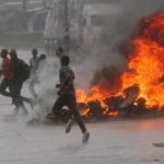 People-run-at-protest-as-barricades-burn-during-rainfall-in-Harare