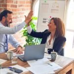 couple-happy-at-workplace-laughing